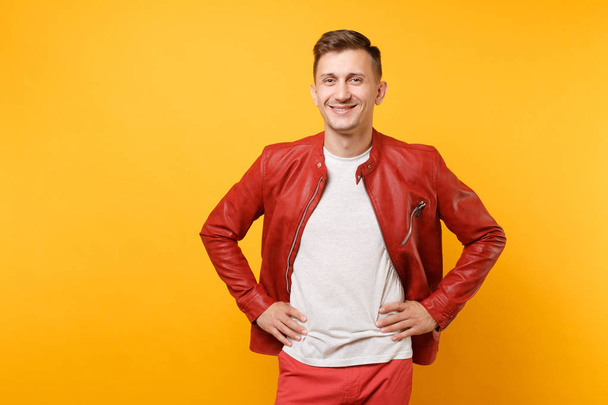 Portrait vogue smiling handsome young man 25-30 years in leather jacket, t-shirt standing isolated on bright trending yellow background. People sincere emotions lifestyle concept. Advertising area - Фото, зображення