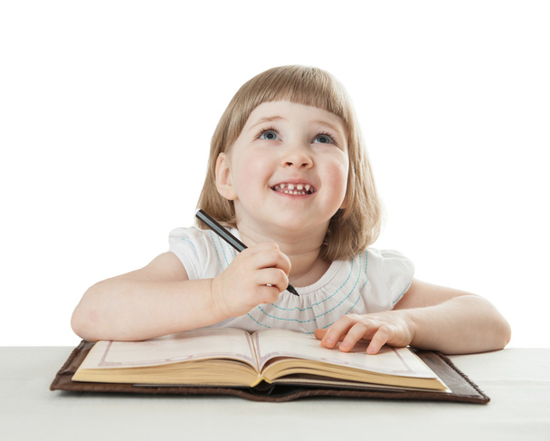 Little child with a pen and a book - Фото, зображення