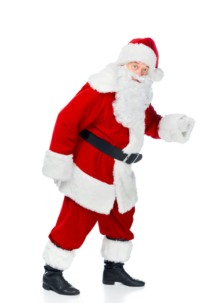 bearded santa claus walking in red costume isolated on white - Foto, immagini