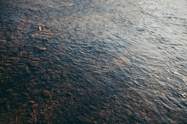 close-up shot of beautiful transparent water over pebbles in mountain river, Carpathians, Ukraine - Photo, Image