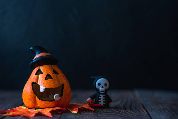 pumpkin in a hat with a face and a skeleton in a hoodie - Photo, Image