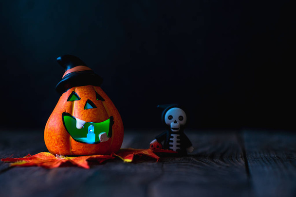 pumpkin in a hat with a face and a skeleton in a hoodie - Фото, зображення