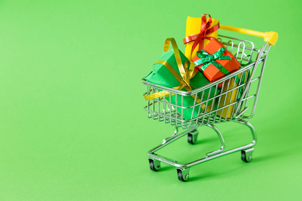 Online shopping concept - trolley cart full of presents - Zdjęcie, obraz