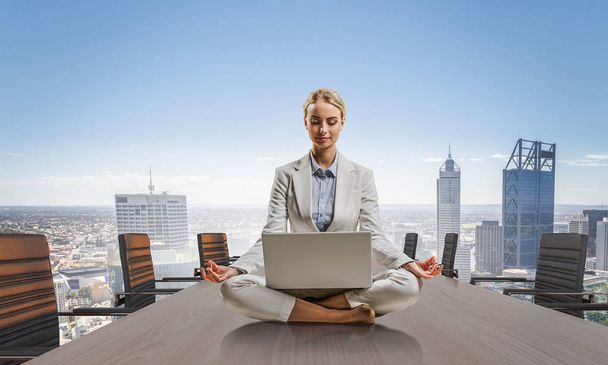 Business lady meditating at work. Mixed media - Valokuva, kuva