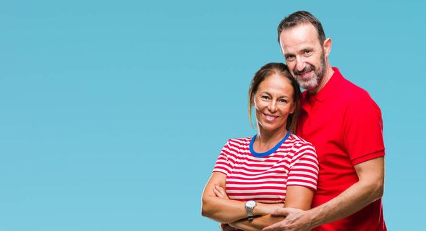 Middle age hispanic couple in love over isolated background with a happy and cool smile on face. Lucky person. - Photo, Image