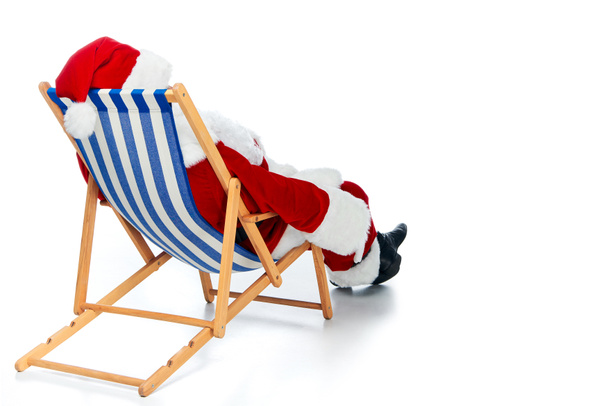 rear view of santa claus relaxing on beach chair on white - Fotoğraf, Görsel