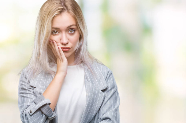 Young blonde business woman wearing jacket over isolated background thinking looking tired and bored with depression problems with crossed arms. - Foto, Bild