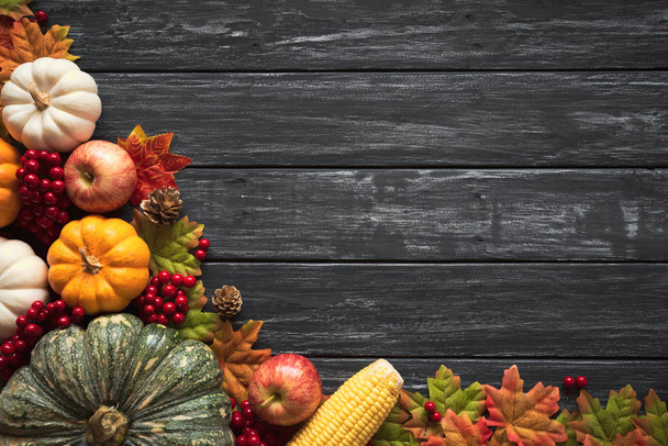 Őszi juharlevelek, a sütőtök és a piros bogyós gyümölcsök a régi fa háttérbeli felülnézet. Hálaadás napja koncepció. - Fotó, kép
