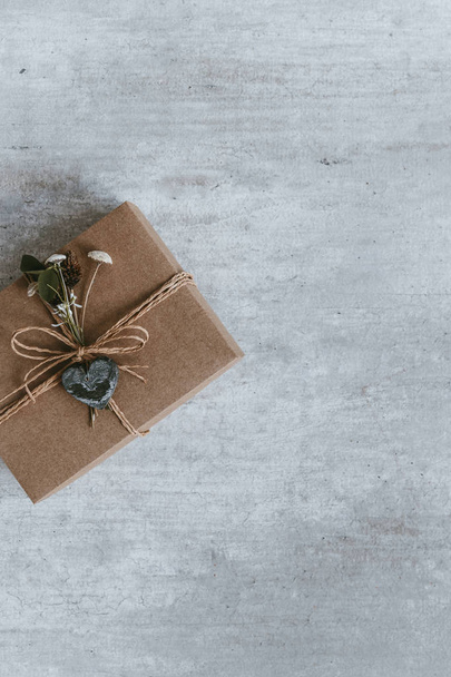 Handmade christmas gift or present box wrapped in kraft paper. Top view, flat lay, copy space. Greeting card. - Фото, зображення