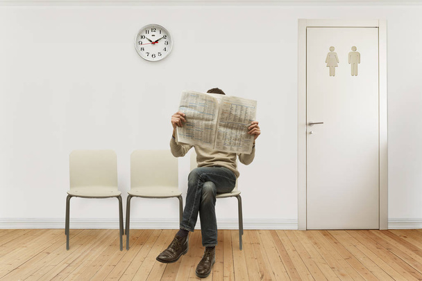 sala de espera con una persona sentada leyendo el periódico
 - Foto, Imagen