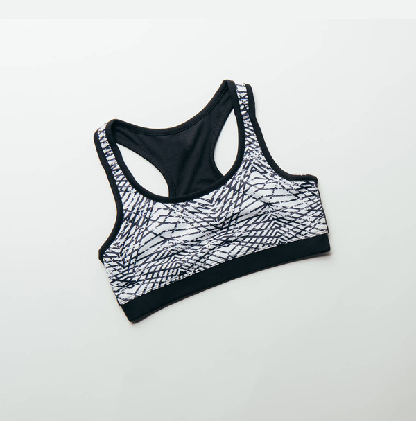 top view of sports bra isolated on white, minimalistic concept  - Foto, immagini