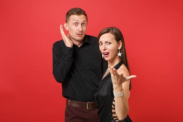 Fun expression young couple in black clothes shirt dress celebrating birthday holiday party isolated on bright red background. St Valentine International Women Day Happy New Year concept. Mock up - Foto, Imagem