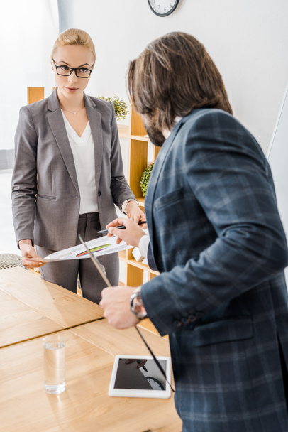 young woman and man standing at meeting in office  - Photo, Image
