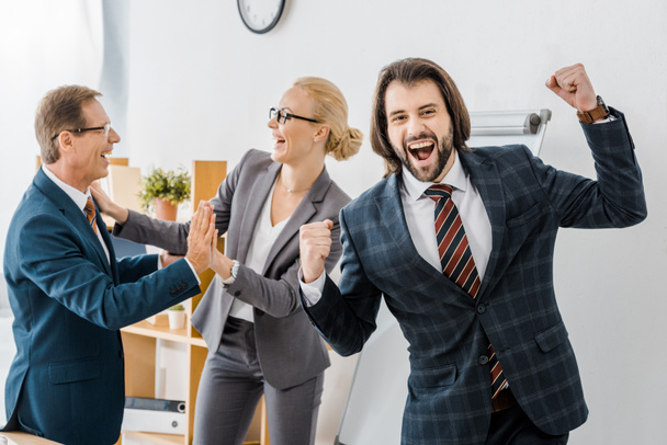 happy insurance agents rejoicing great deal in office - Photo, Image