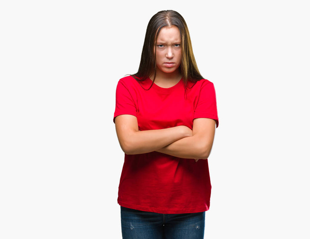 Young beautiful caucasian woman over isolated background skeptic and nervous, disapproving expression on face with crossed arms. Negative person. - Foto, immagini