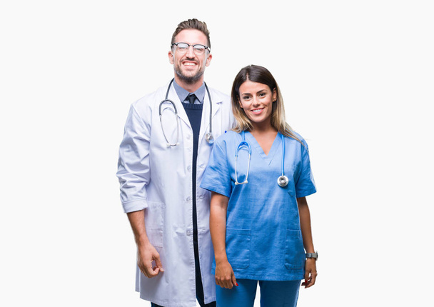 医師と外科医幸せとクールな孤立の背景の上の若いカップルは、顔に笑顔します。幸運な人. - 写真・画像