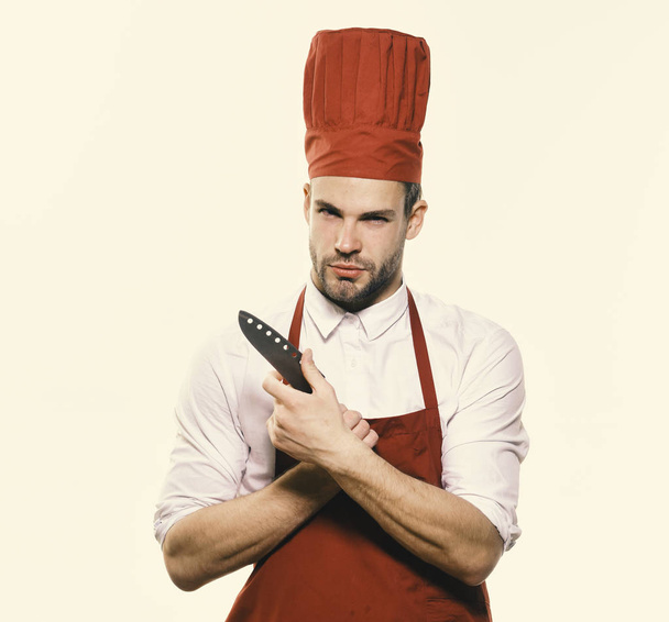 Cook with curious face holds knife. Kitchenware and cooking concept. - Fotó, kép
