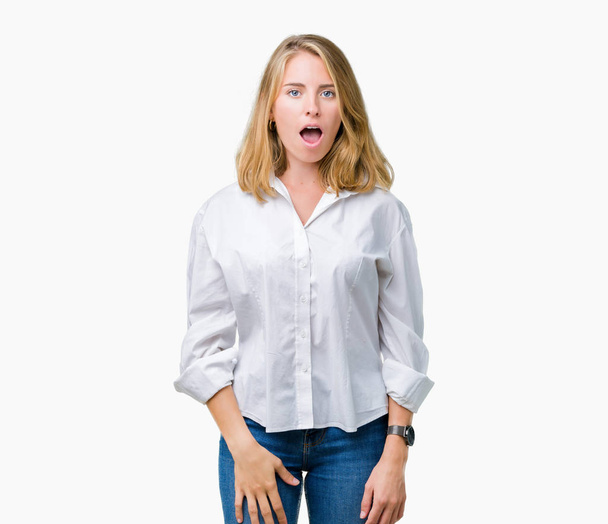 Beautiful young business woman over isolated background In shock face, looking skeptical and sarcastic, surprised with open mouth - Foto, immagini