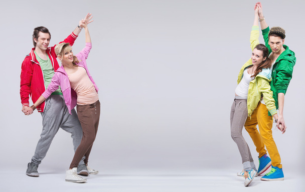 Two hip-hop couples dance and smile - Фото, изображение