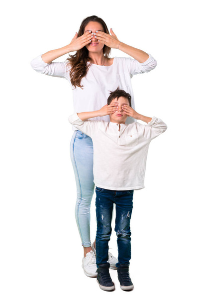 Mother and son covering eyes by hands - Foto, Bild