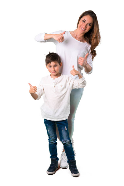 Mother and son giving a thumbs up gesture and smiling - Foto, afbeelding