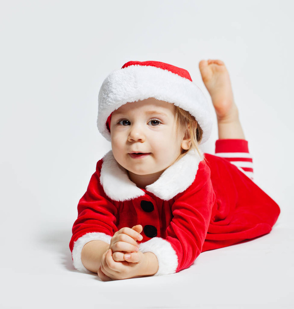 Cheerful baby in Santa hat on white background - Photo, Image