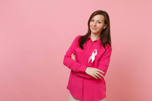 Donna in abiti rosa con nastro di seta rosa simbolo isolato su sfondo parete pastello, ritratto in studio. Oncologia ginecologica sanitaria medica, concetto di Sensibilizzazione al Cancro al Seno. Falsificare spazio di copia
 - Foto, immagini