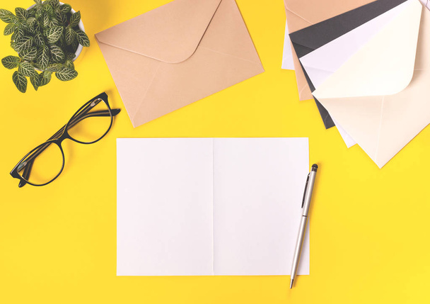 Creative workspace desk on bright yellow background. - Photo, Image