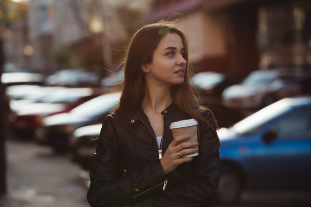 Woman enjoying to walking with coffee cup in city street - Zdjęcie, obraz