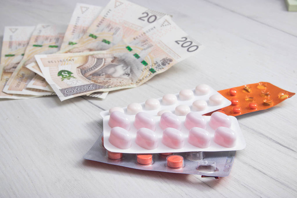 Pills and polish zloty bills. medicine pills health cost polish money zloty pln concept - Foto, Imagen