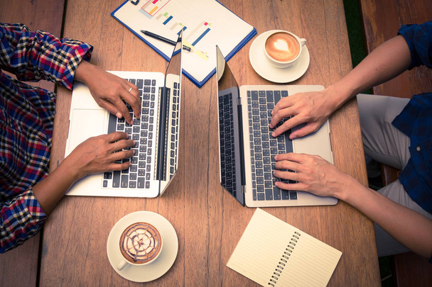 twee ondernemers werken samen met behulp van laptop; werk bedrijfsconcept - Foto, afbeelding