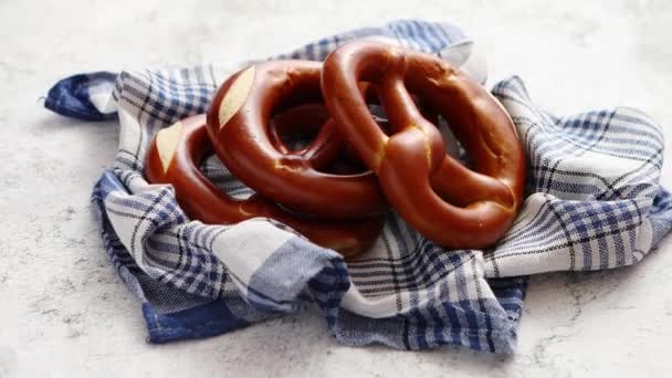 Three german fresh baked pretzel buns placed on napkin - Footage, Video