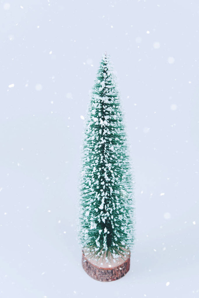 Christmas tree over light blue background. - Φωτογραφία, εικόνα