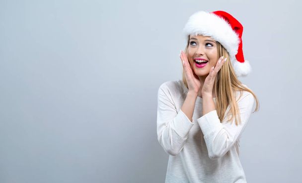Happy woman with a Santa hat - Фото, зображення