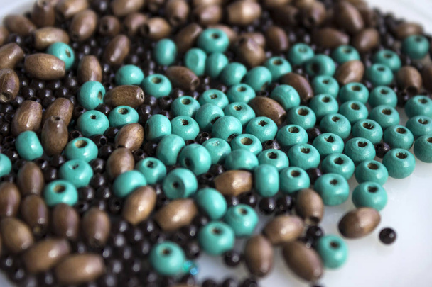 Brown and turquoise wooden beads background. Handmad - Photo, Image