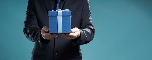 Businessman holding  the present box to give somebody - Photo, Image