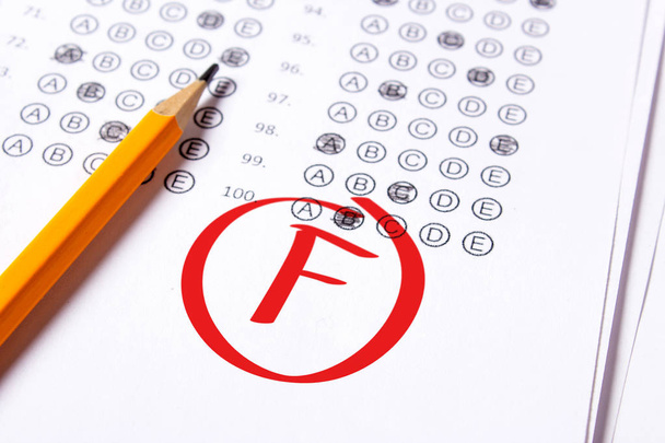 Bad grade F is written with red pen on the tests - Photo, Image