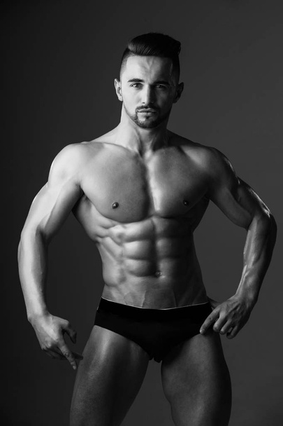 muscular man with muscle torso in studio, sport and training - Valokuva, kuva