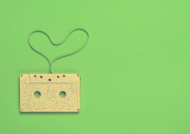 Kalp şekilden yeşil Kağıt arka plan, üstten görünüm üzerinde ses kaset. Hipster aşk - Fotoğraf, Görsel