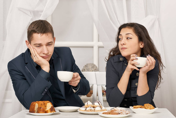 romantic couple drinking tea with cookies and talking - Fotoğraf, Görsel