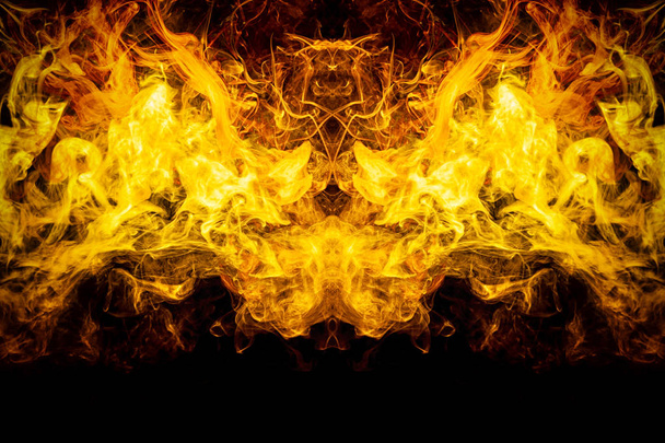 Fluffy Puffs  yellow and orange smoke and Fog in the form of a skull, monster, dragon  on Black Background. Fantasy print for clothes: t-shirts, sweatshirts - Photo, Image