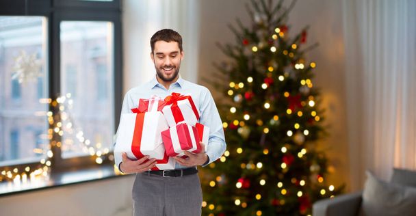 happy man with christmas gifts at home - Photo, Image