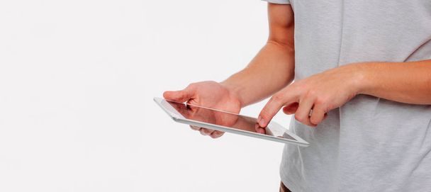 Tablet in men's hands on a white background, banner - Φωτογραφία, εικόνα