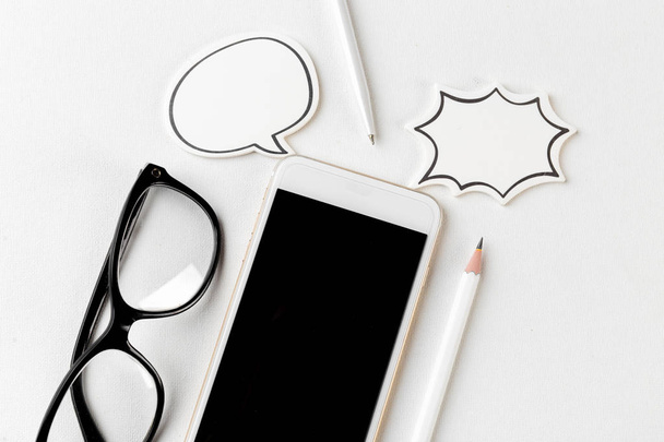 close nup of phone with blank speech bubble on white background  - Foto, Imagen