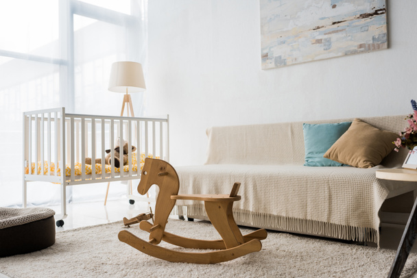 modern interior design of nursery room with crib and rocking horse chair - Photo, Image