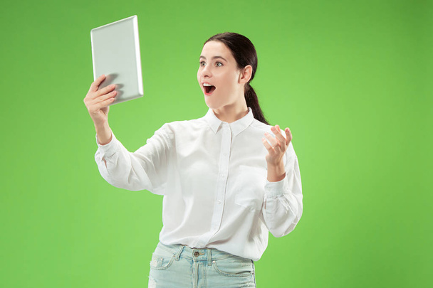 Businesswoman with laptop. Love to computer concept. Attractive female half-length front portrait, trendy green studio backgroud. Young emotional pretty woman. Human emotions, facial expression - Foto, immagini