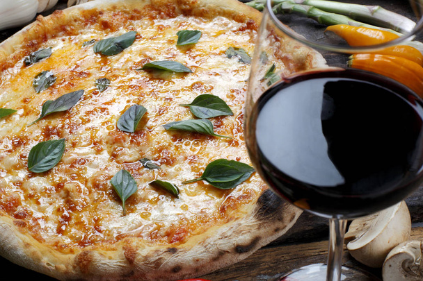 Pizza with glass of red wine - 写真・画像