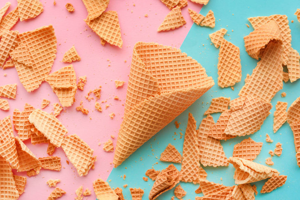 Ice cream waffle cones on pastel pink and blue background, top view flat lay modern minimal composition - Foto, Bild
