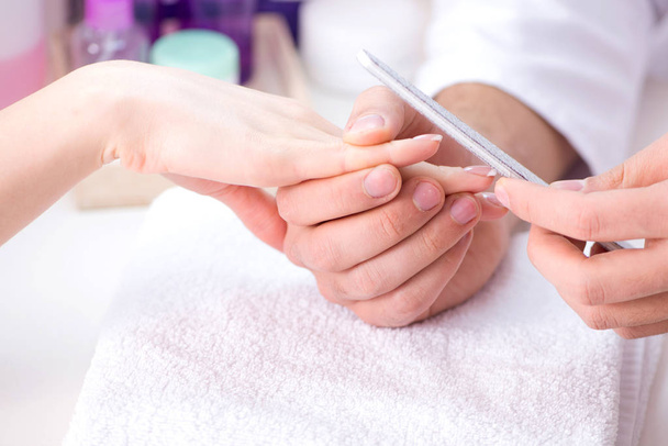Hands during manicure care session - Φωτογραφία, εικόνα