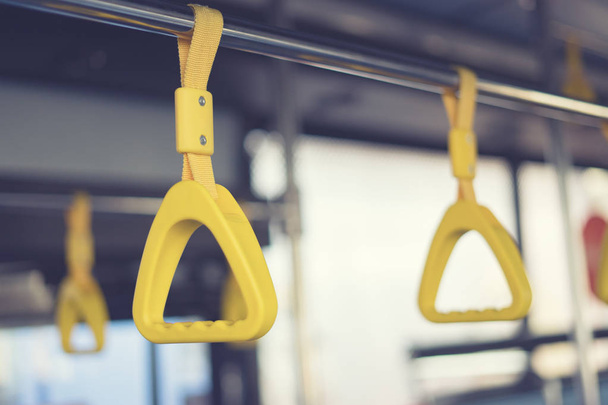 selective focus of Handles hanging from ceiling of bus - Zdjęcie, obraz
